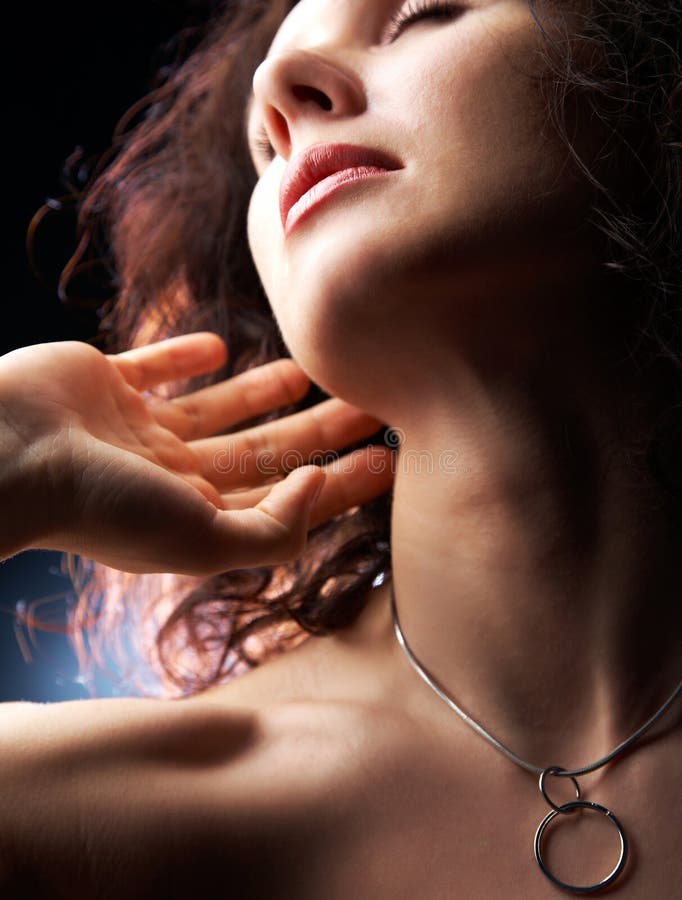 Sensual beautiful woman touches her fingers to the neck. Sensual beautiful woman touches her fingers to the neck