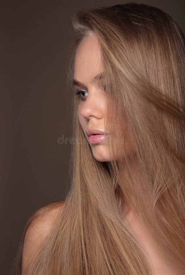 Sensual woman model with shiny straight long blond hair.