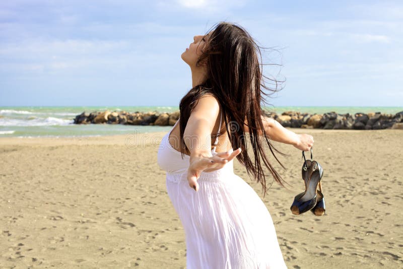 Beautiful woman feeling the nature the wind and the sea. Beautiful woman feeling the nature the wind and the sea