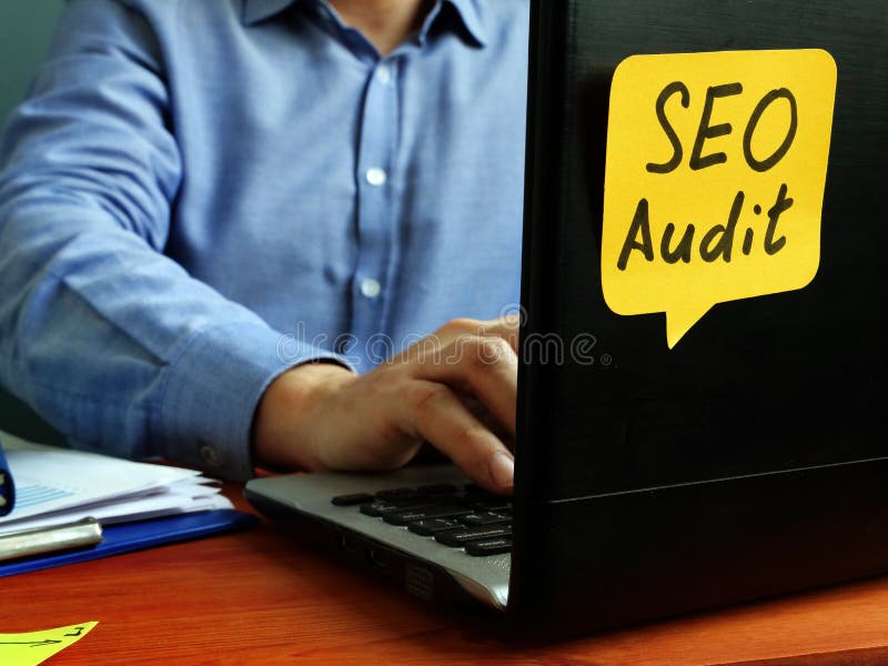 SEO audit concept. Specialist working with laptop royalty free stock image