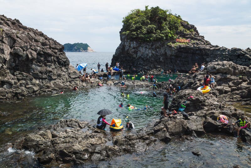 Natural Pool with a crowd of tourists and locals swimming at Seogwipo, Jeju Island, South Korea royalty free stock photography Natural Pool with a crowd of tourists and locals swimming at Seogwipo, Jeju Island, South Korea royalty free stock photography