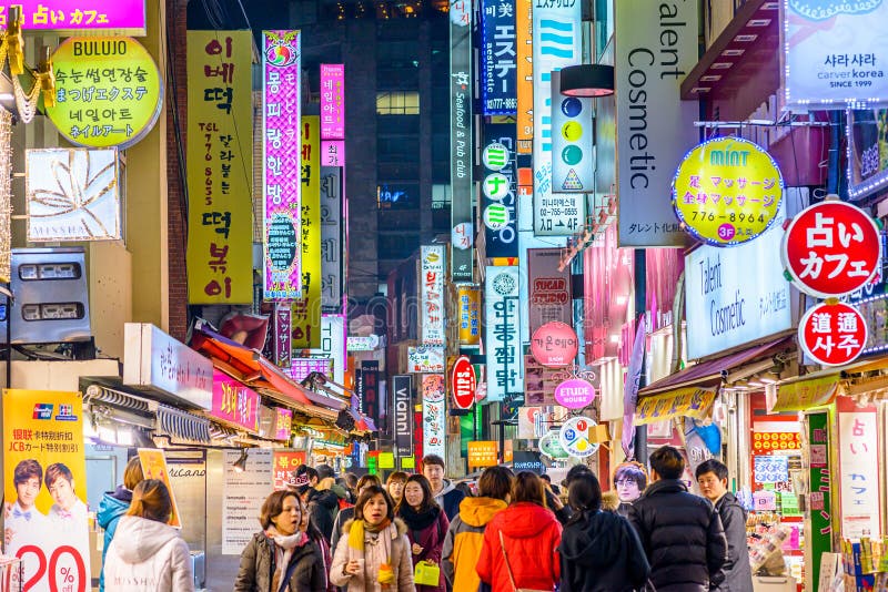 SEOUL, SOUTH KOREA - FEBRUARY 14, 2013: Crowds enjoy the Myeong-Dong district nightlife in Seoul. SEOUL, SOUTH KOREA - FEBRUARY 14, 2013: Crowds enjoy the Myeong-Dong district nightlife in Seoul.
