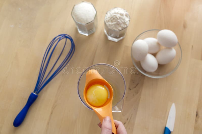 Separating Yellow Yolks from Protein in Raw Eggs for Cake, Biscuit and Cream. Stock Photo
