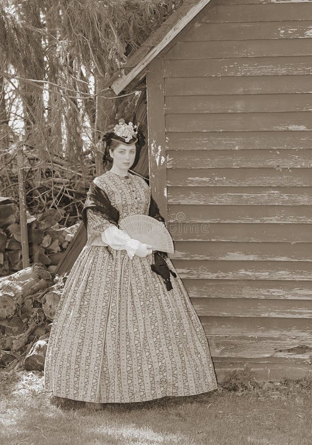 Outdoor sepia portrait of an attractive young girl in a Civil War era 1860s dress. Outdoor sepia portrait of an attractive young girl in a Civil War era 1860s dress