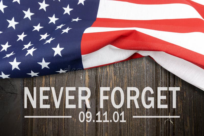 9/11 Patriot Day, September 11. `Never Forget` Text and USA flag on wooden wall. 9/11 Patriot Day, September 11. `Never Forget` Text and USA flag on wooden wall.