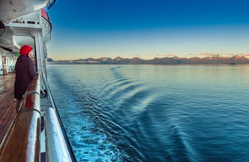 September 14, 2018 - Stephen`s Passage, AK: Woman on cruise viewing mountains.