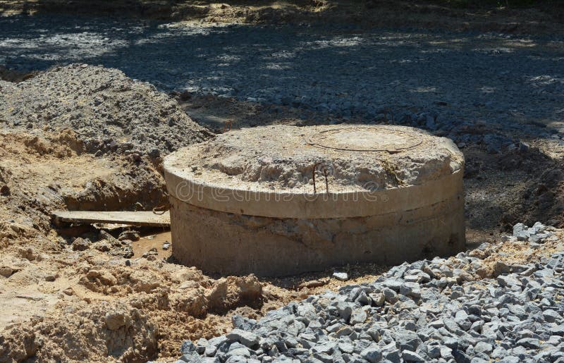 Premium Photo | Installation of concrete sewer wells in the ground at the  construction site the use of reinforced concrete rings for cesspools  overflow septic tanks improvement of wells and storm sewage