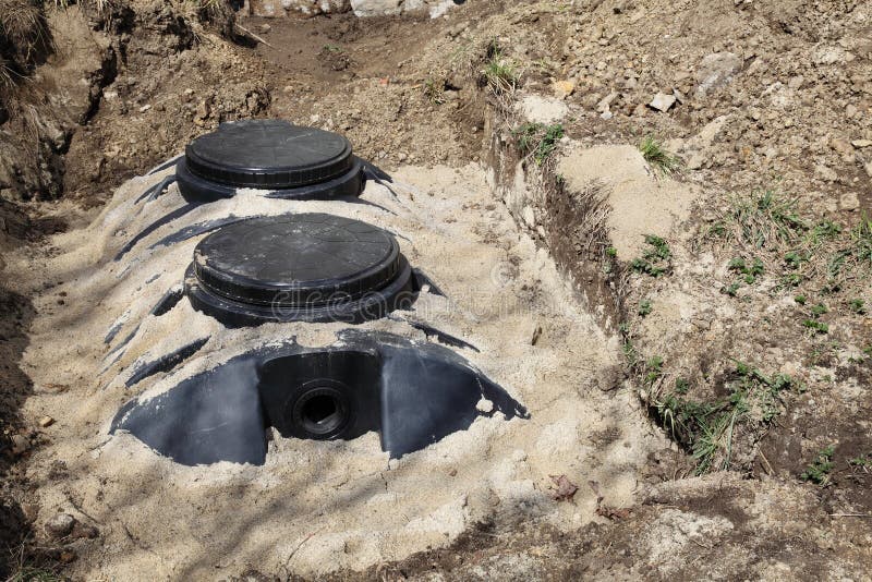 A close up view of a newly installed septic tank system at a residential property for removal and purification of household grey wastewater and sewage. A close up view of a newly installed septic tank system at a residential property for removal and purification of household grey wastewater and sewage.