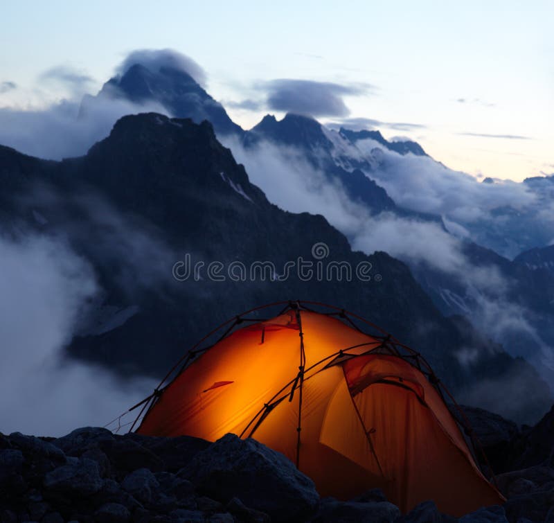 Lighting tent at evening in mountains. Lighting tent at evening in mountains