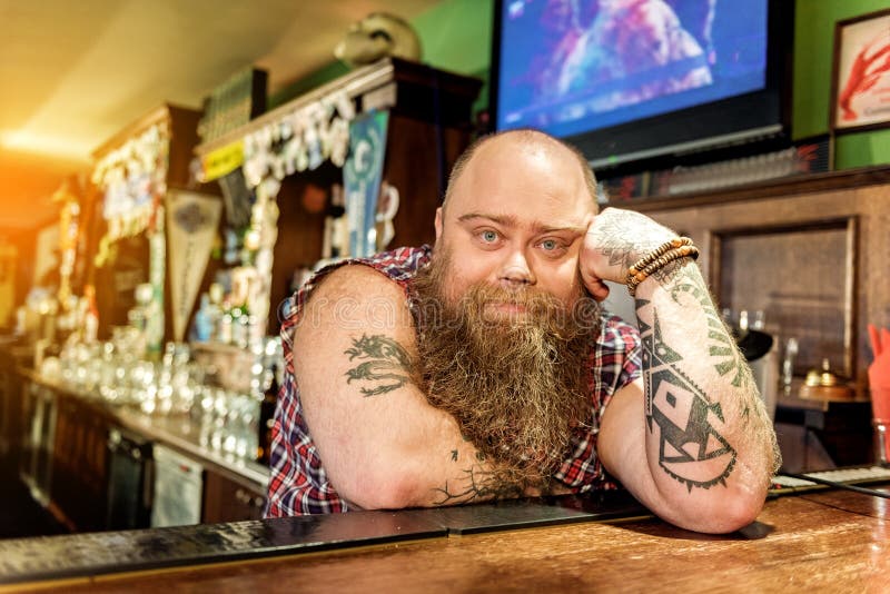 Serene fat bartender reclining on worksurface