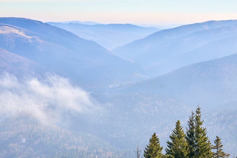 Serene mountain landscape with misty valleys and pine forests at sunrise royalty free stock images