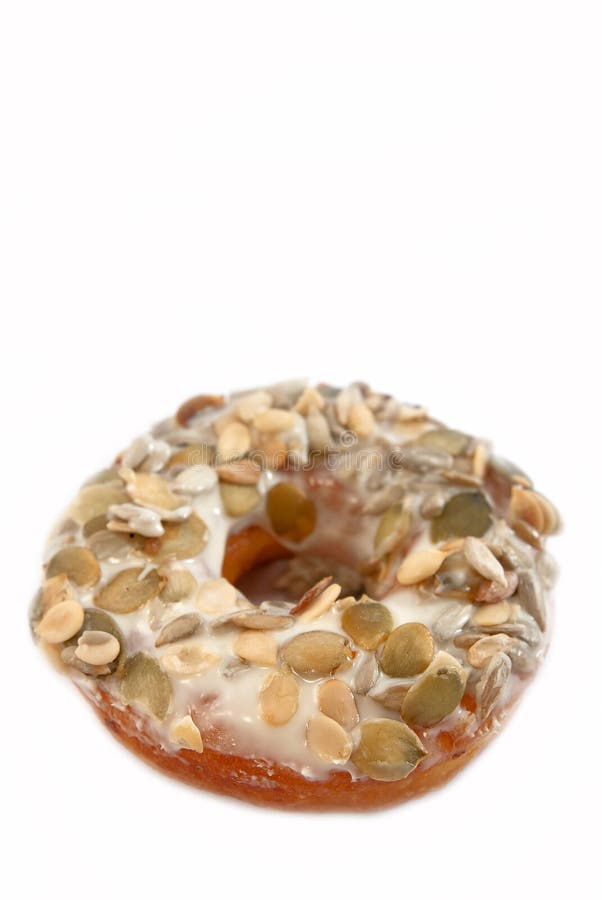 White Chocolate Pumpkin Seeds Donut on white background. White Chocolate Pumpkin Seeds Donut on white background