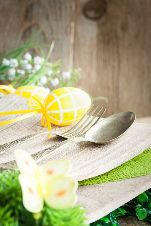 Restaurant menu series. Easter place setting. Fork and knife in rustic country table setting. Restaurant menu series. Easter place setting. Fork and knife in rustic country table setting