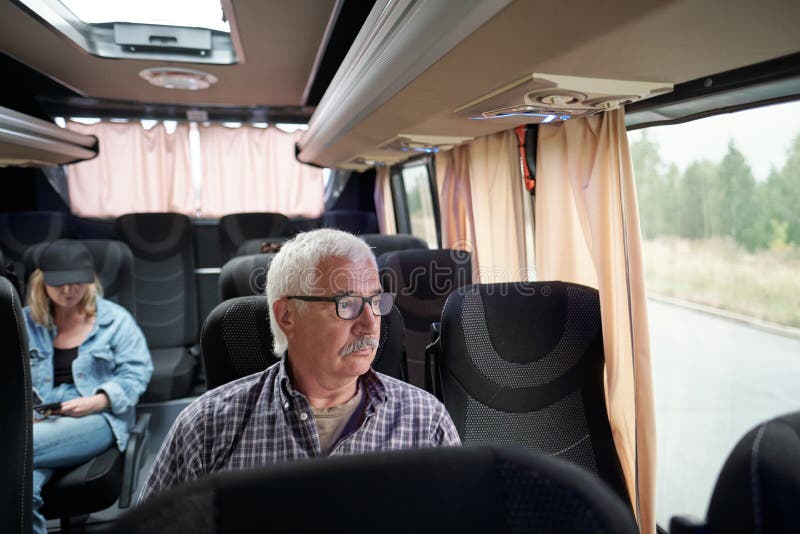 A Man is Sitting on the Bus Near a Glass Window with Steam Stock