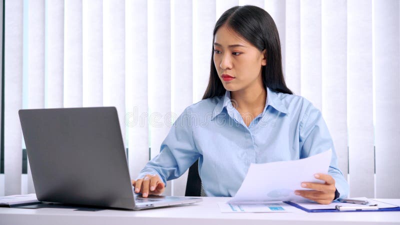 Serious asian business woman Strong headache because working hard and stress from hard work in office