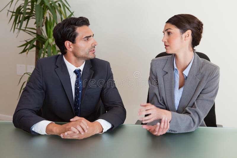 Serious business people negotiating in a meeting room. Negotiating table stock images, royalty-free photos and pictures