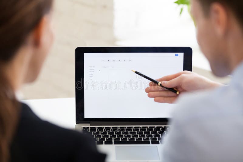 Serious businessman and businesswoman using laptop, white mockup royalty free stock images