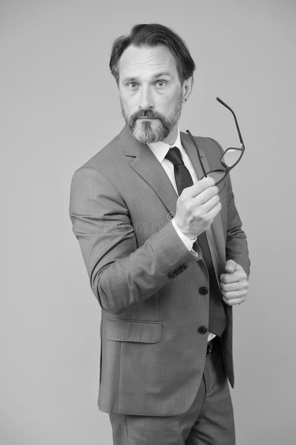 Serious businessman. Education for adults. Perplexedly removes glasses. Business education. Self education. Teacher royalty free stock images
