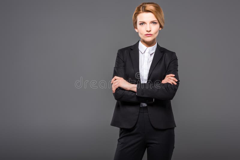 serious businesswoman posing in suit with crossed arms