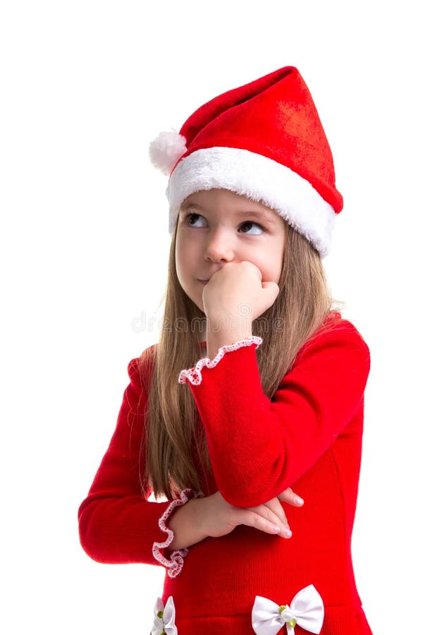 Serious christmas girl with the fist under the chin, looking up, wearing a santa hat isolated over a white background stock photography Serious christmas girl with the fist under the chin, looking up, wearing a santa hat isolated over a white background stock photography