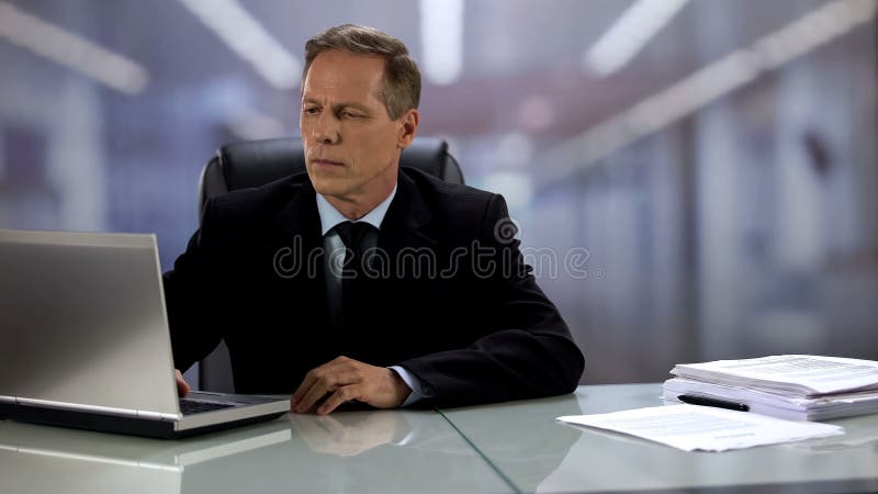 Serious company boss working at laptop, answering e-mail, professionalism royalty free stock photos Serious company boss working at laptop, answering e-mail, professionalism royalty free stock photos