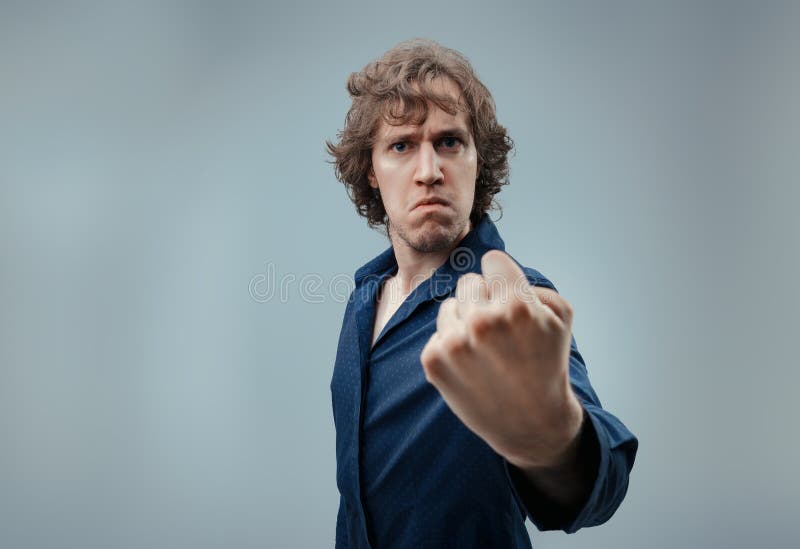 Serious expression paired with a confrontational fist royalty free stock photo