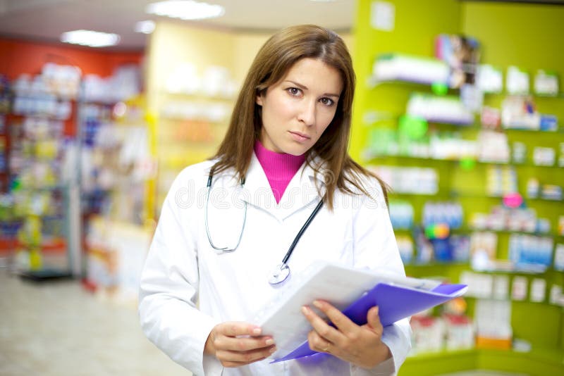 Serious Female Doctor In Pharmacy With Documents Stock Image Image of doctor, caucasian 26148835