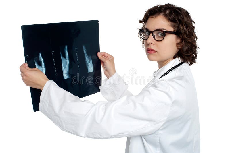 Serious female doctor showing the x-ray sheet stock photo Serious female doctor showing the x-ray sheet stock photo