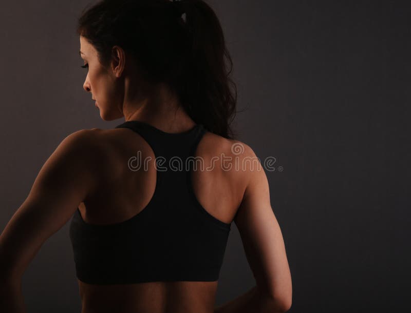 Muscular back of a woman in sportswear stock photo (121815) - YouWorkForThem