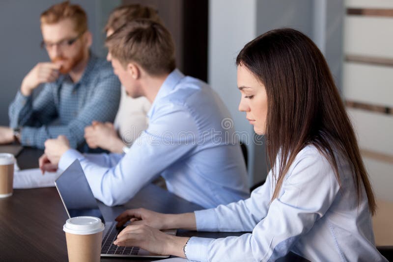 Serious focused businesswoman working typing on laptop in office royalty free stock photo Serious focused businesswoman working typing on laptop in office royalty free stock photo