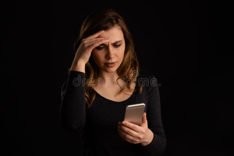 Serious frustrated girl holding phone in arm and do not understand what is going on. stock photos Serious frustrated girl holding phone in arm and do not understand what is going on. stock photos