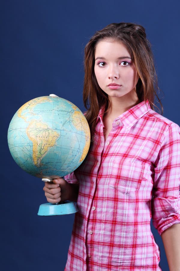 Serious girl in plaid shirt holds Globe.