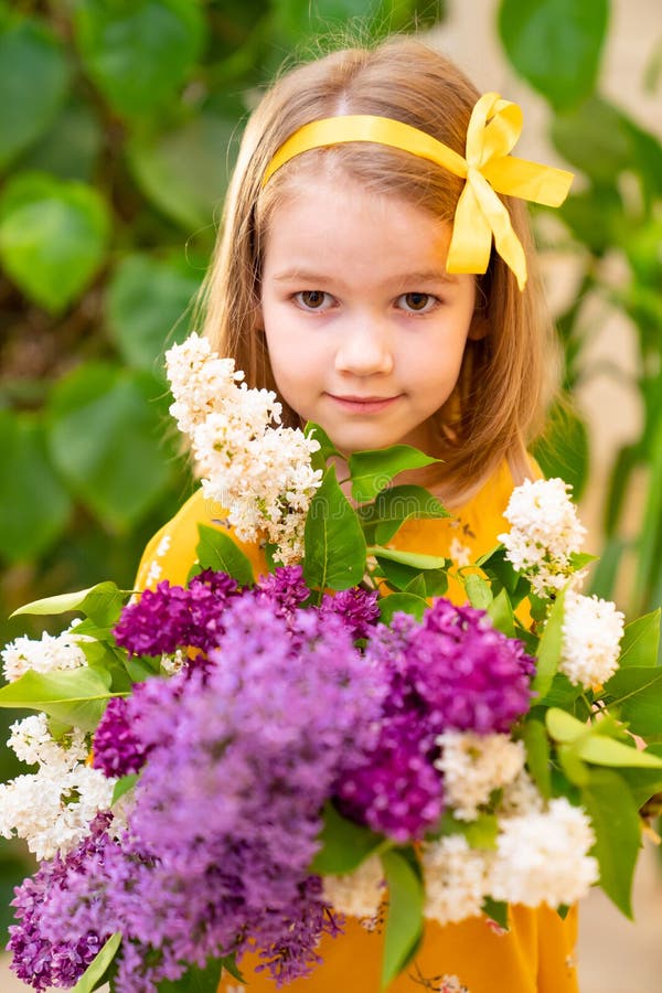 Serious Girl in Yellow Dress with Bouquet Lilac Stock Photo - Image of ...