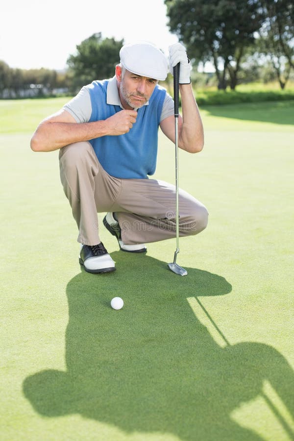 Serious Golfer Kneeling on the Putting Green Stock Image Image of