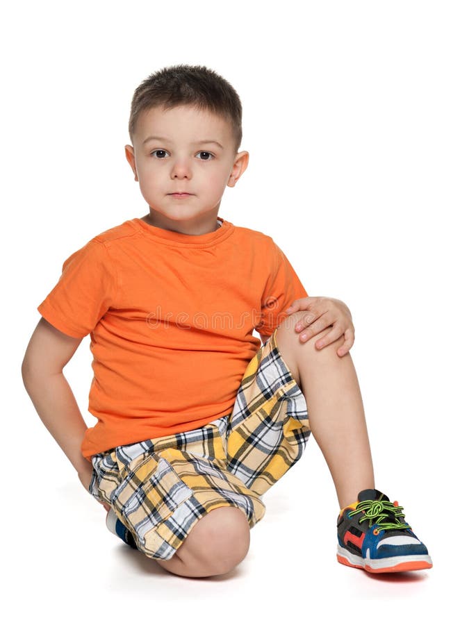 Serious Little Boy In The Orange Shirt Stock Image Image of sitting