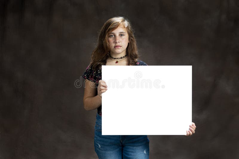 Serious Looking Pre-Teen Girl With Freckles Holding Blank Sign