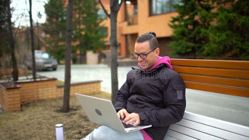 Serious man with laptop working. Hispanic Ethnicity Young Man using Laptop Computer. stock footage