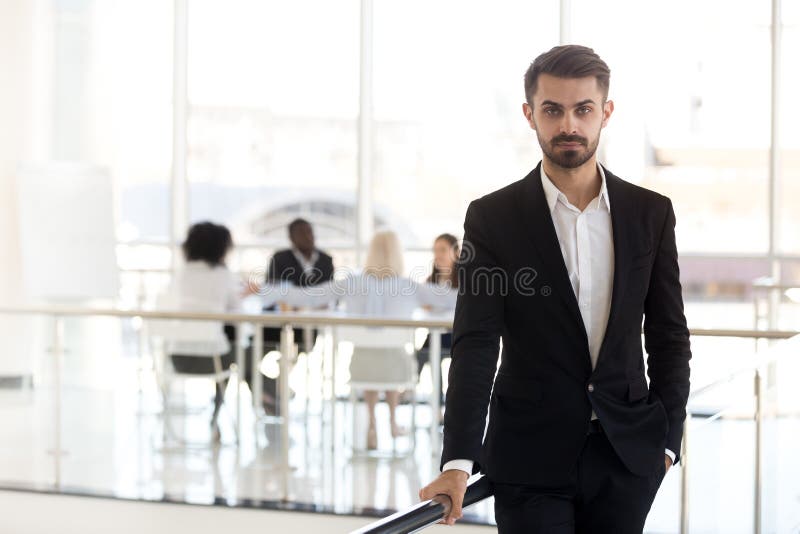 Serious millennial corporate leader or executive ceo looking at stock photos Serious millennial corporate leader or executive ceo looking at stock photos
