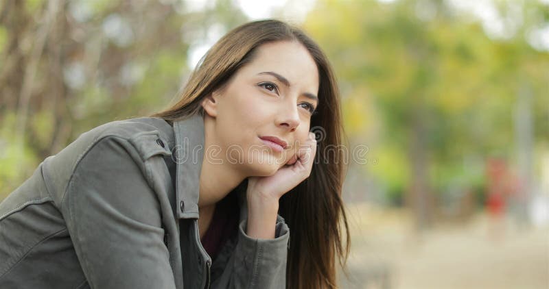 Serious pensive woman looking away in a park