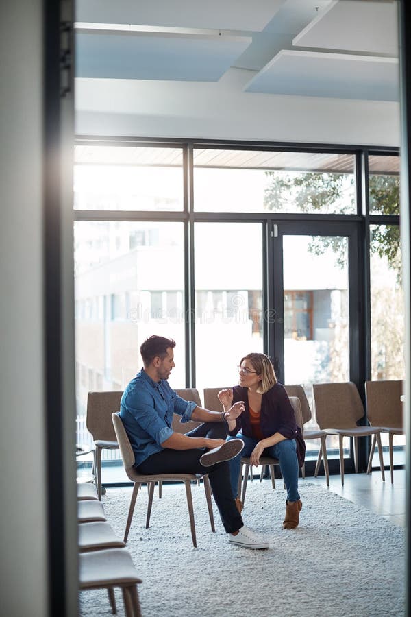 Serious, professional business woman talking to work colleague in modern startup office. Manager having casual