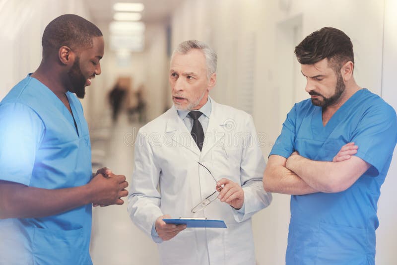 Serious professor showing his folder royalty free stock images Serious professor showing his folder royalty free stock images