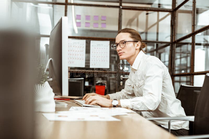 Serious smart man sitting at the computer royalty free stock images Serious smart man sitting at the computer royalty free stock images