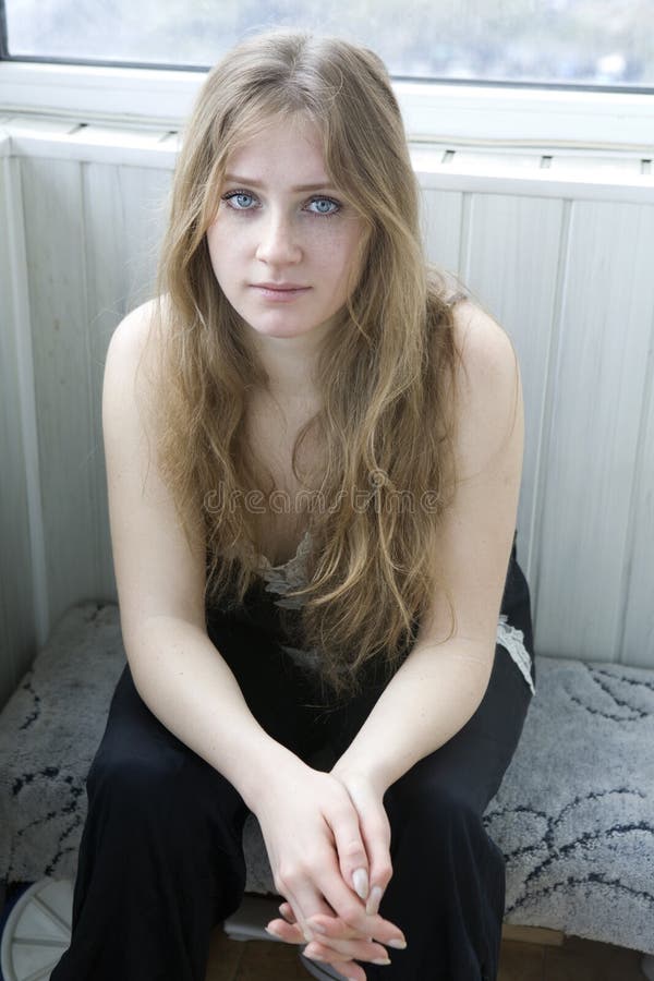 Serious Teen Girl With Long Hair Sitting Stock Image I