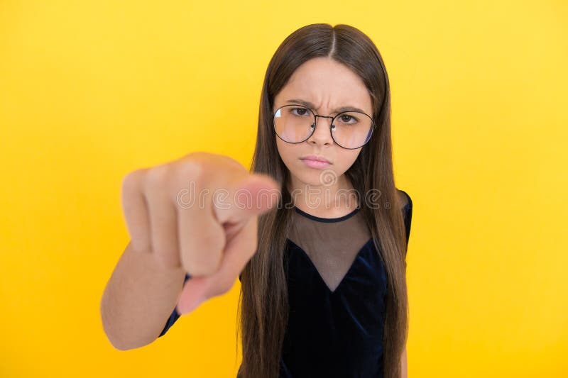 Serious Teen Girl Wearing Glasses because of Bad Eyesight and Pointing ... photo