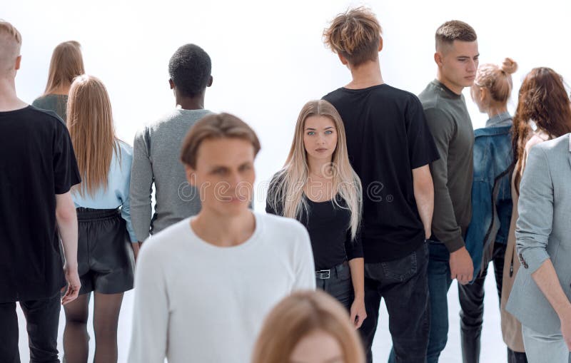 Serious woman standing in front of casual group of young people royalty free stock images