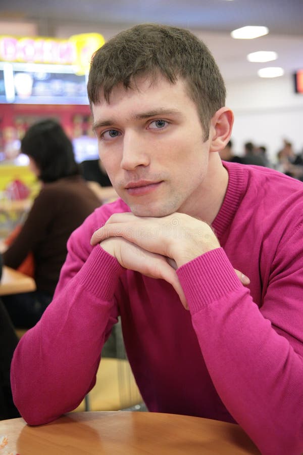 Serious young man in cafe