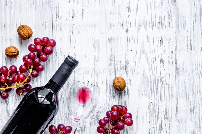 Serve Wine. Bottle, Glass, Nuts and Grape on Wooden Table Background
