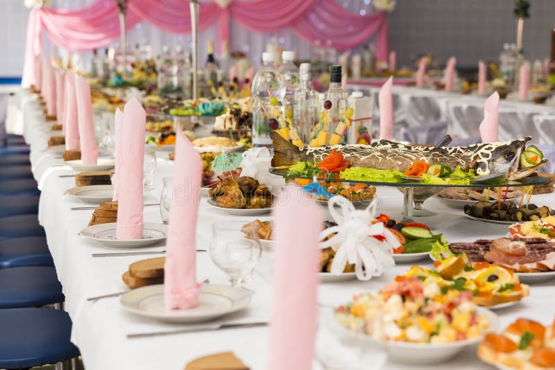 Served for a banquet table. Wine glasses with napkins, glasses and salads.