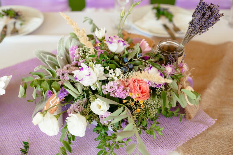 Served with bouquet medow flowers and lavander dinning table restaurant light summer colors weeding day