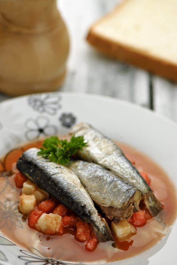 Served sardines with vegetables sauce